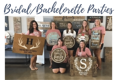 a group of people holding a sign posing for the camera