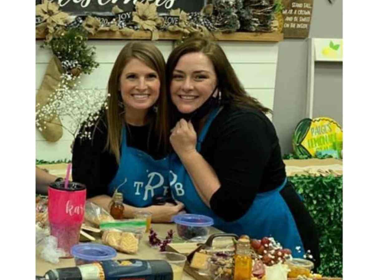 a woman standing in front of a cake