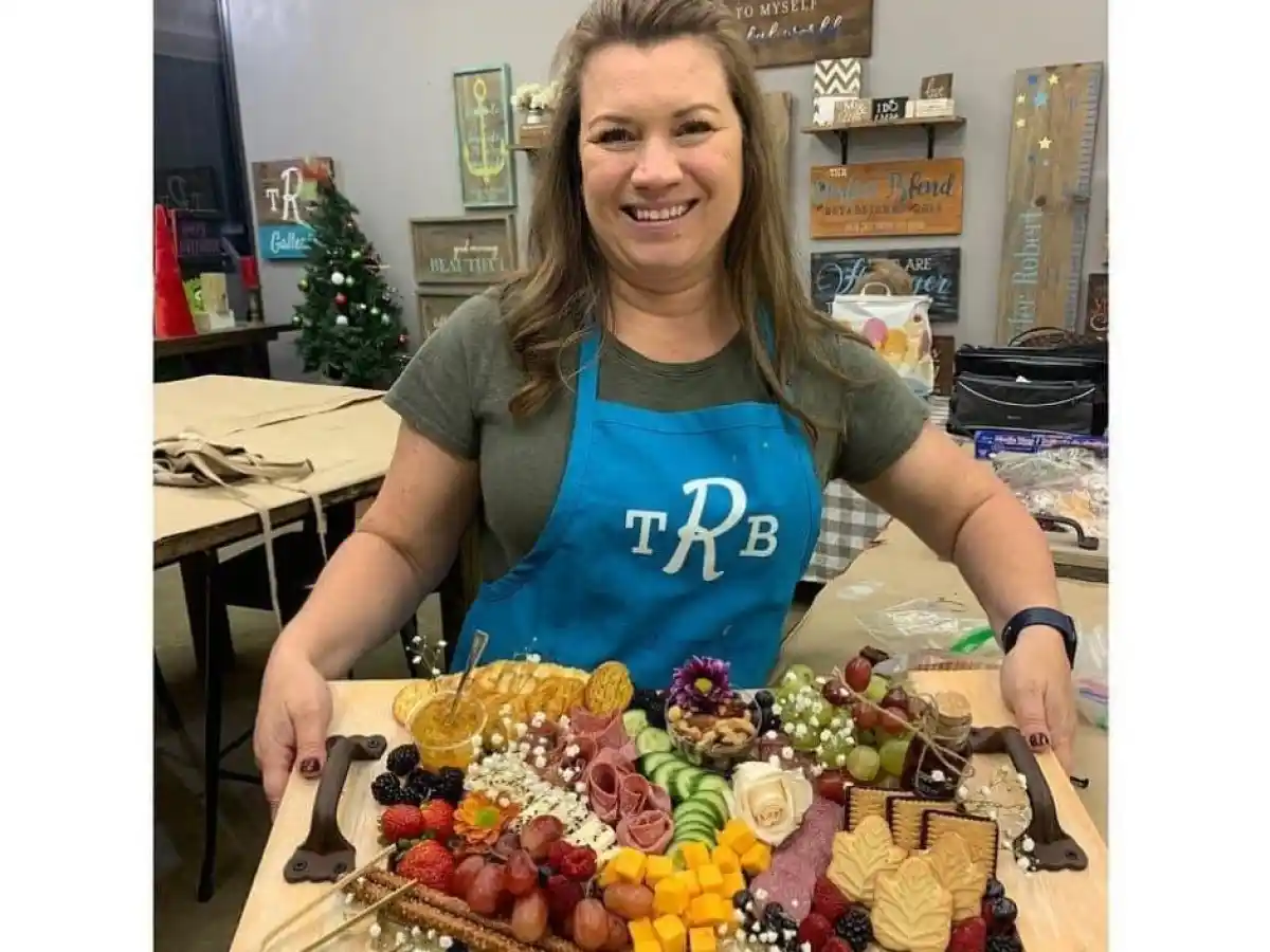 a woman standing in front of a cake