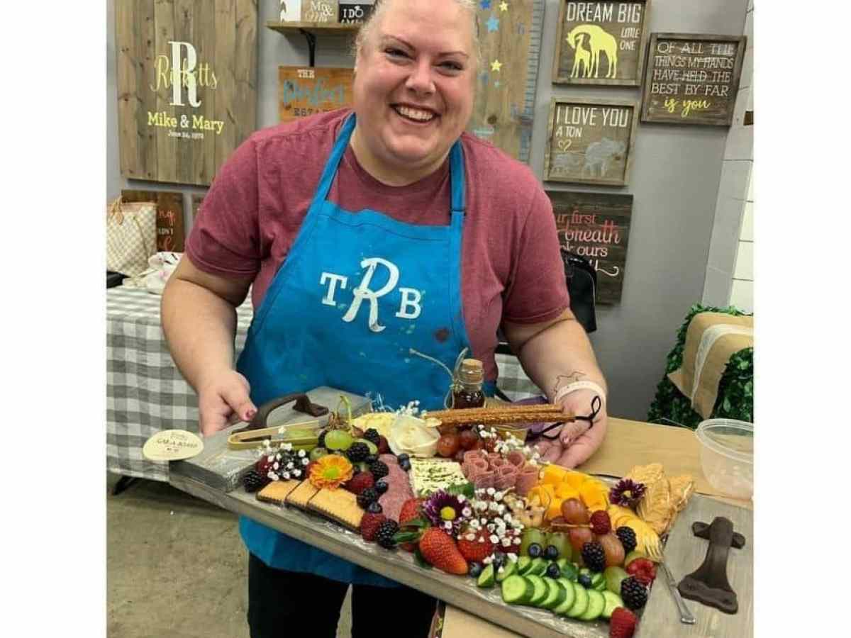 a person standing in front of a tray of food