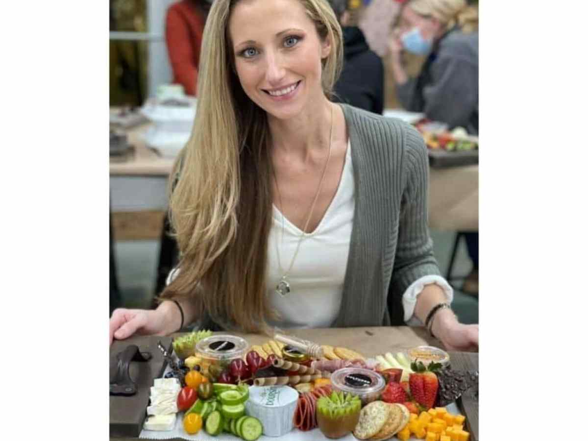 a woman standing in front of a fruit