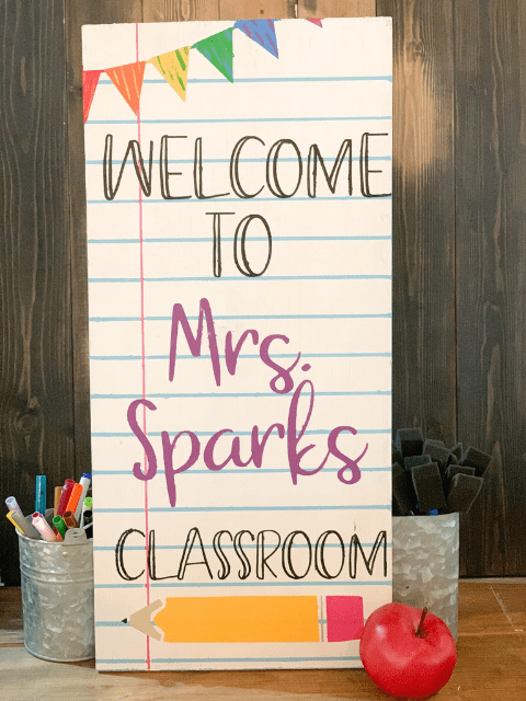 Sign reads 'Welcome to Mrs. Sparks Classroom' with colored pencils and an apple nearby.