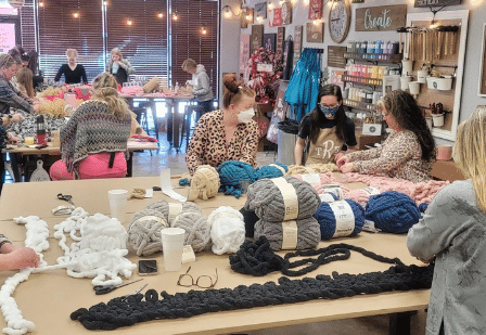 a group of people sitting on display in a store