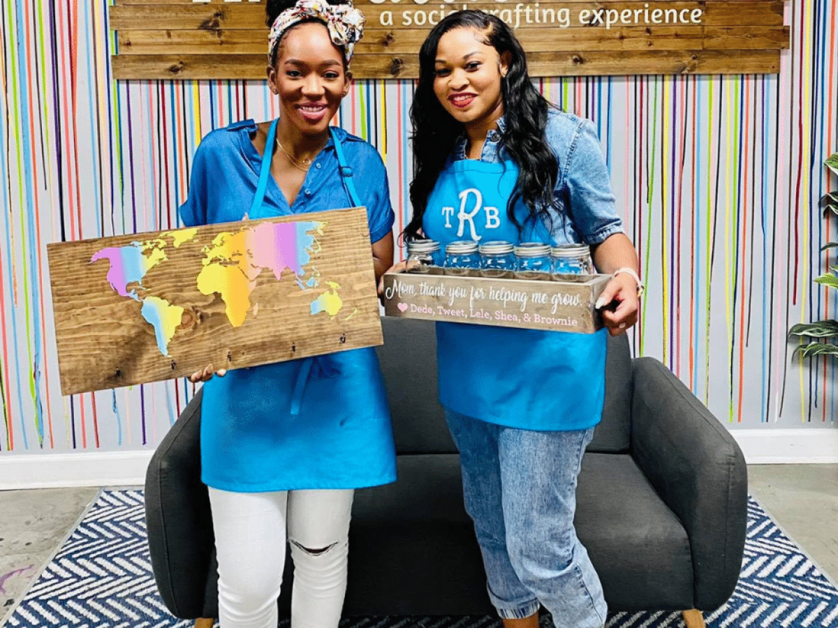 a woman standing in front of a blue wall