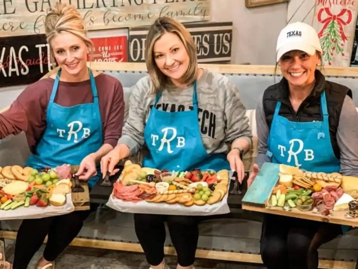 a group of people sitting at a table with a plate of food