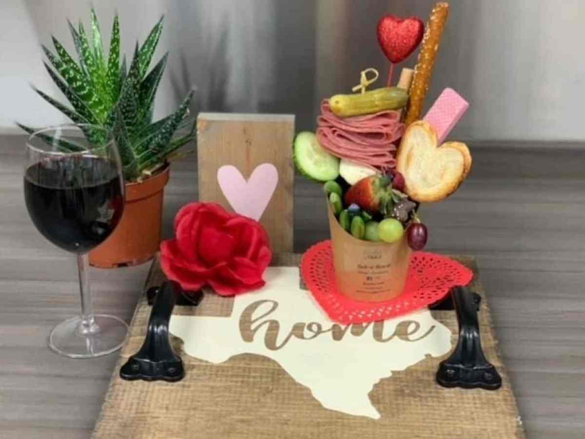 a vase of flowers sitting on top of a wooden table