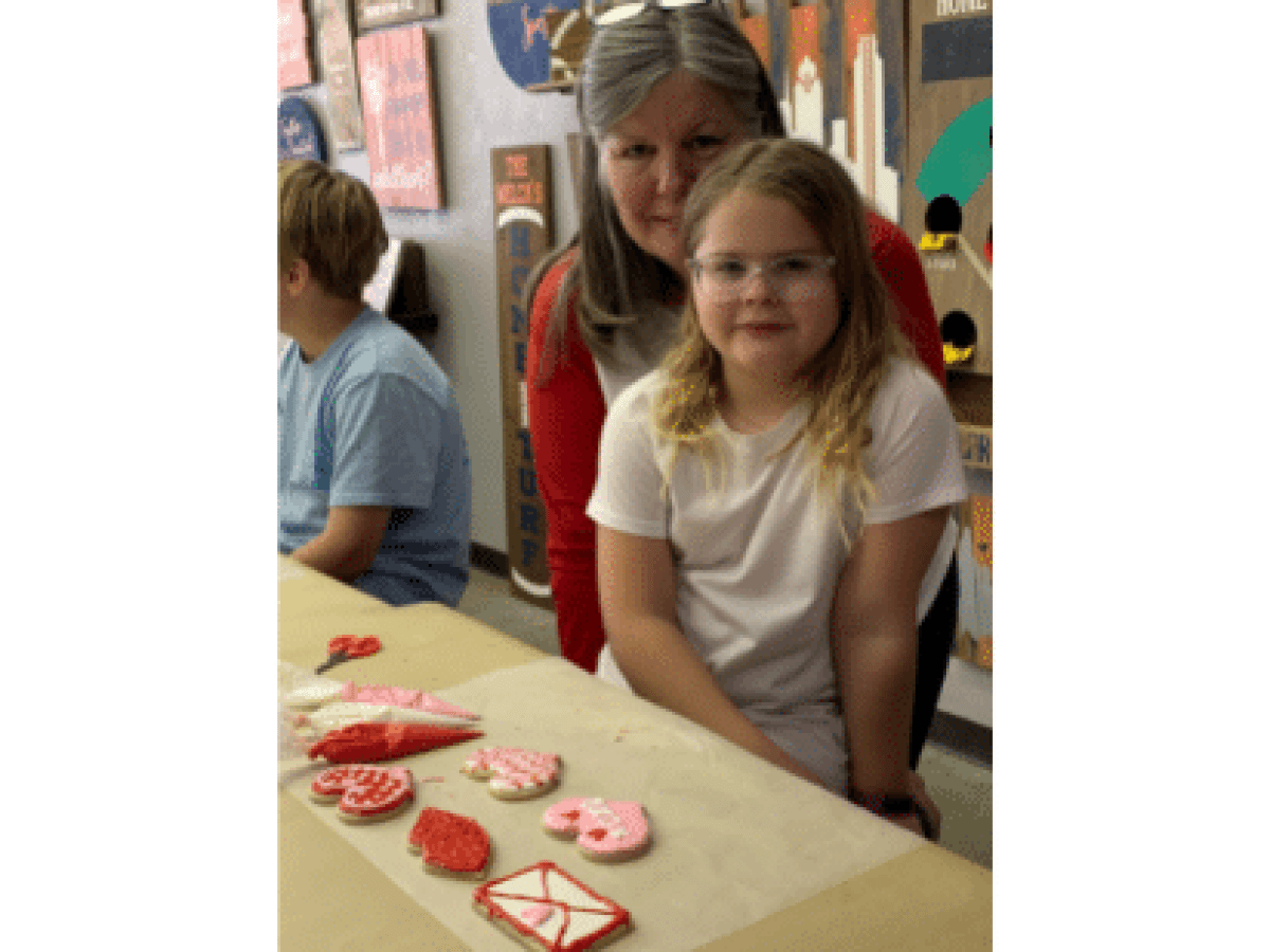a person standing in front of a birthday cake
