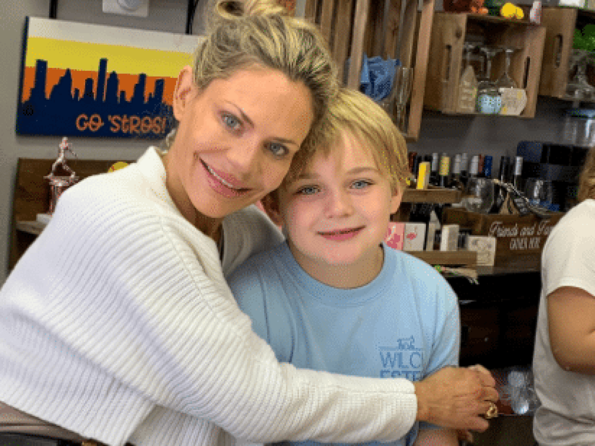 a couple of people standing around a table