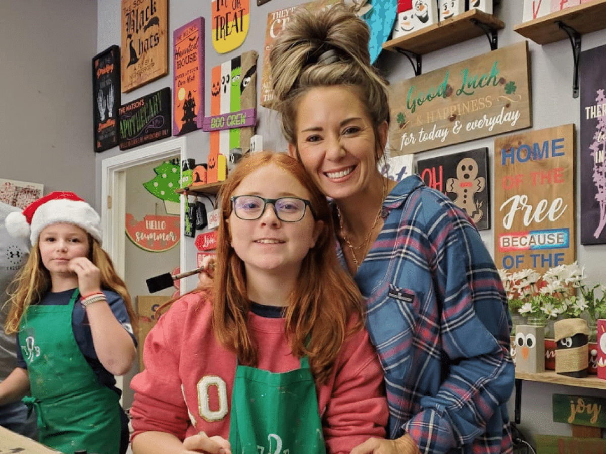 a group of people sitting in front of a store