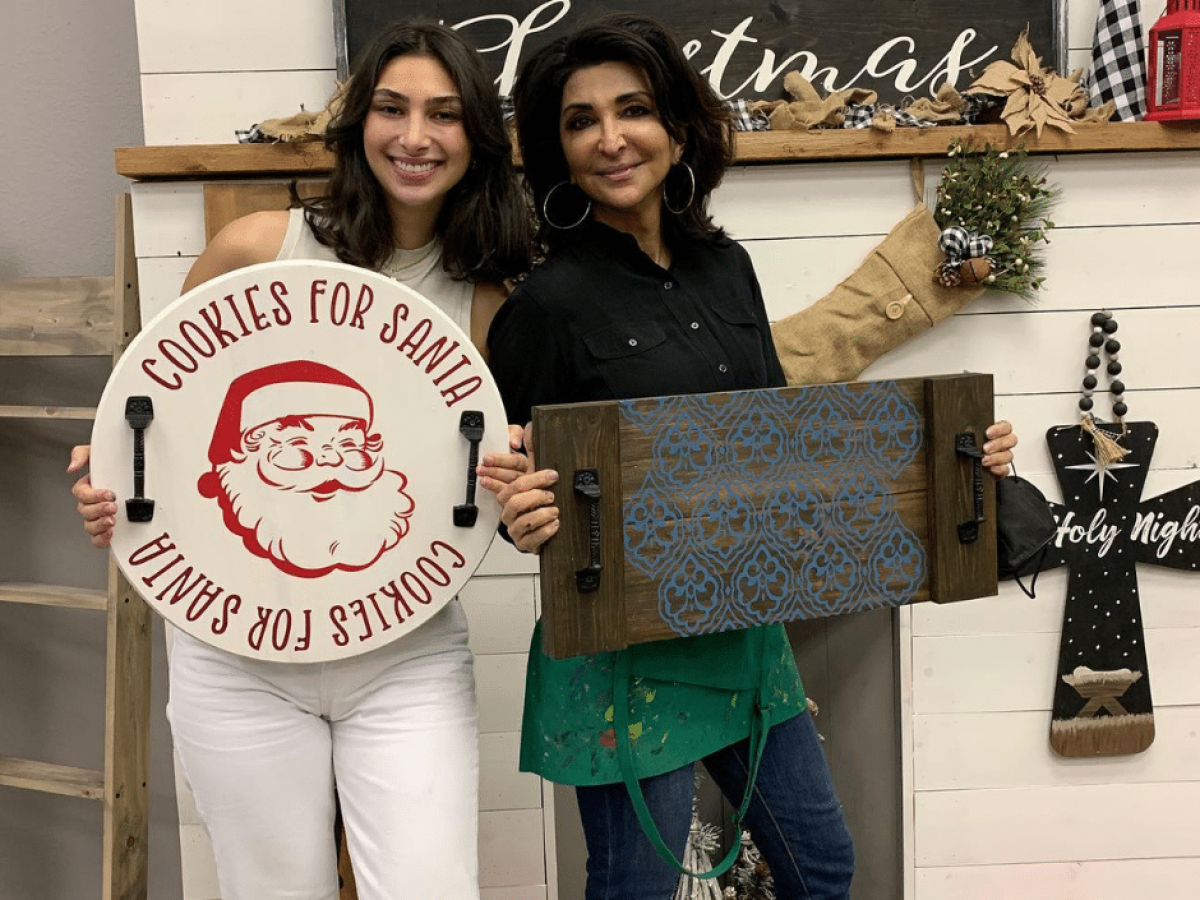 Camilla D'Alfonso holding a sign posing for the camera