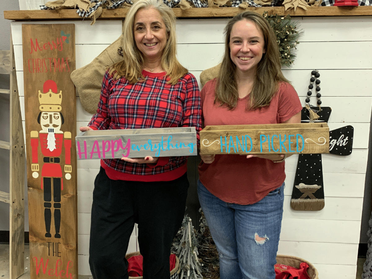 a woman holding a sign posing for the camera