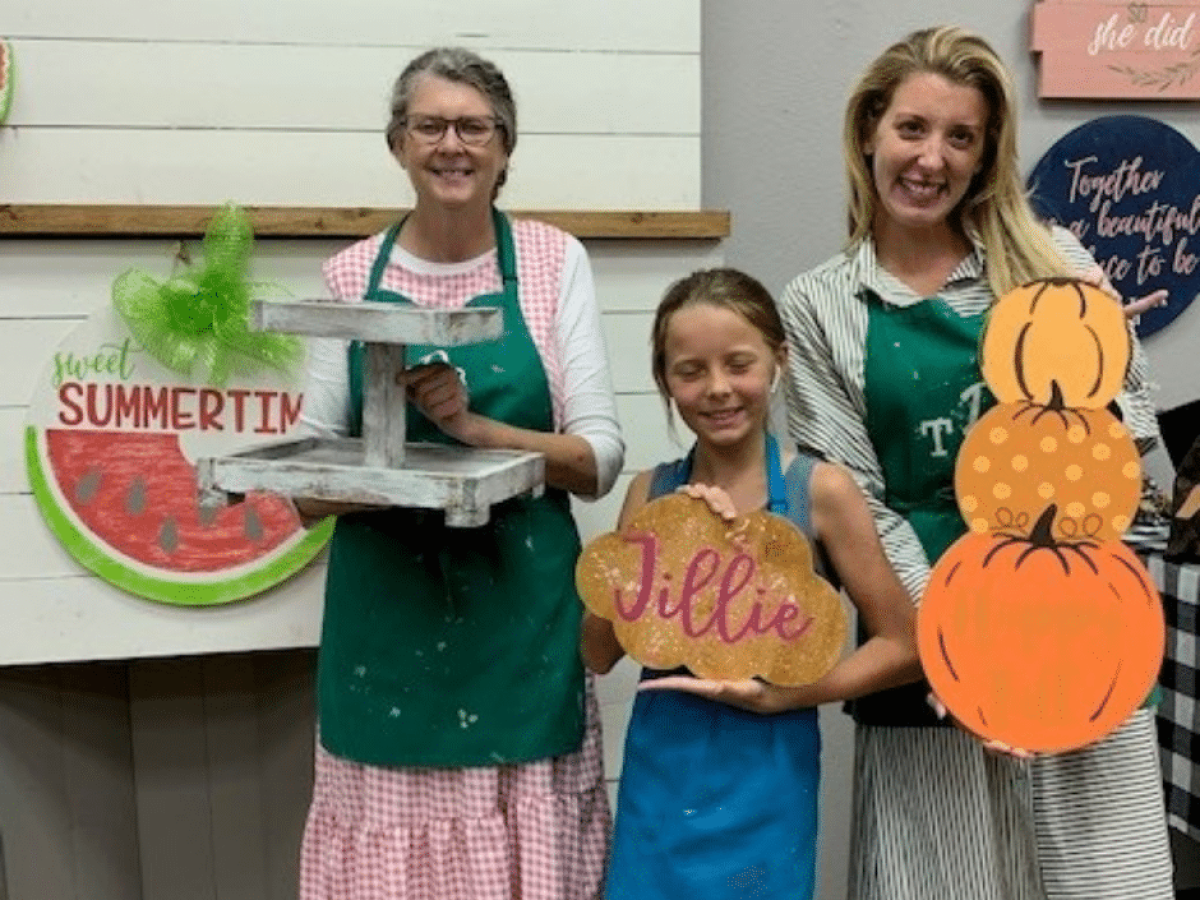 a group of people holding a sign posing for the camera