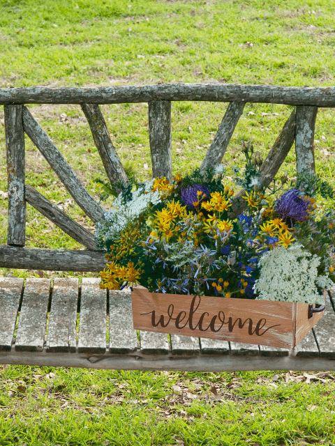 a wooden bench sitting on top of a lush green field