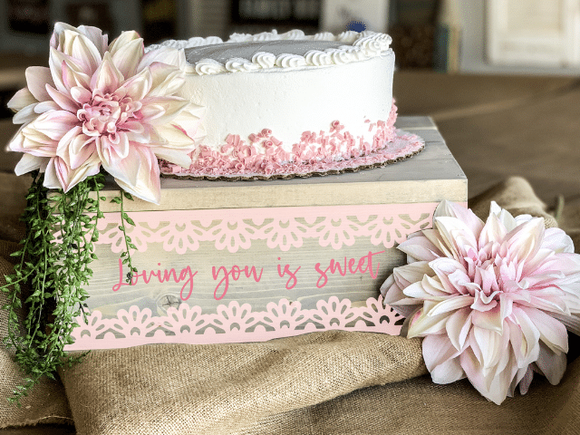 a vase of flowers sitting on top of a wedding cake