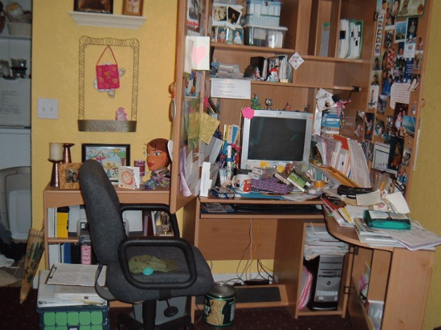 a desk with a book shelf