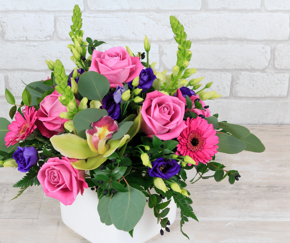 a bouquet of flowers in a vase on a table