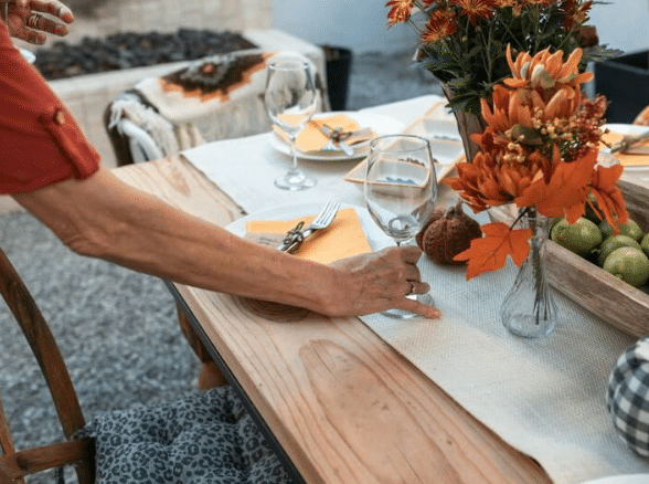 a vase of flowers sitting on top of a wooden cutting board