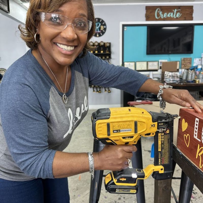 Group of kids joyfully jumping indoors with colorful decorations on the wall behind them.