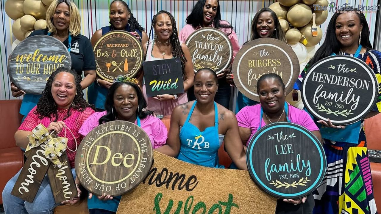 Group of women posing with personalized family and home signs.