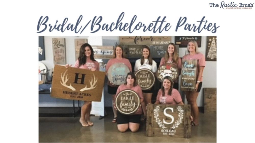Women at craft workshop holding custom signs during Bridal Shower celebration.