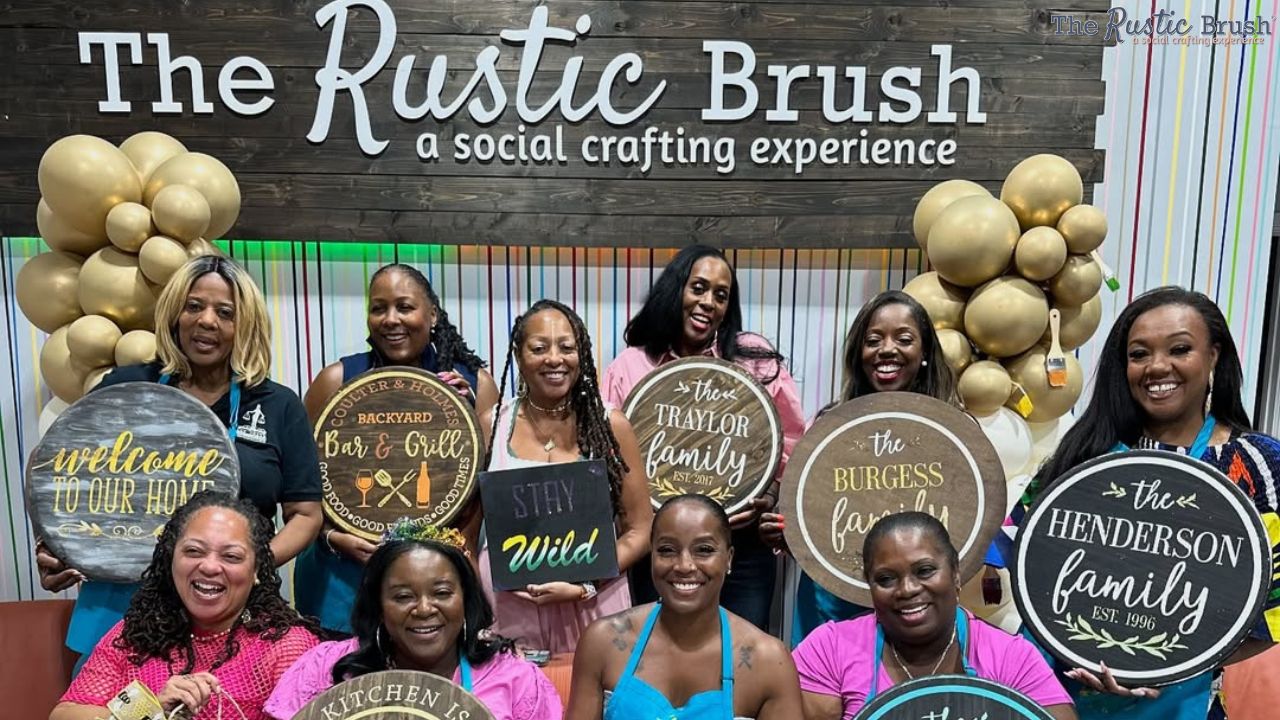 Group celebrating birthday at Houston DIY wood sign crafting workshop.
