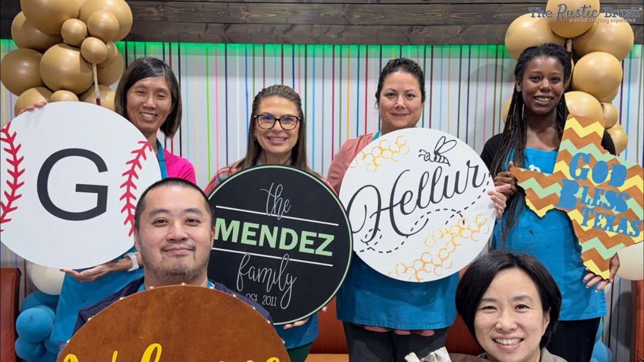 Corporate team crafting custom wood signs at Houston DIY workshop.