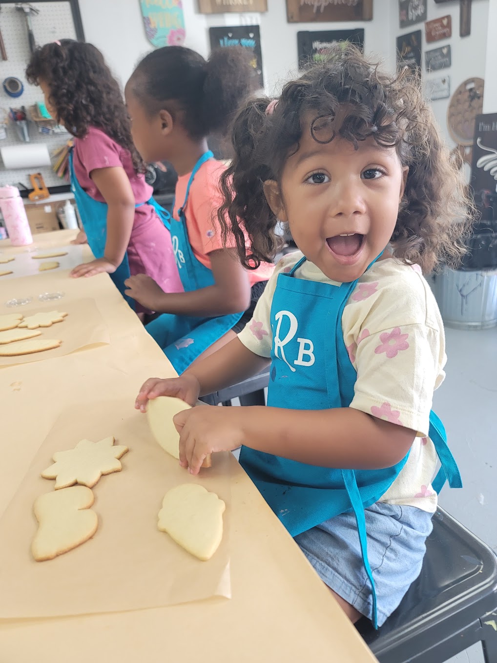 Young child participating in a hands-on DIY craft activity at The Rustic Brush in Houston.