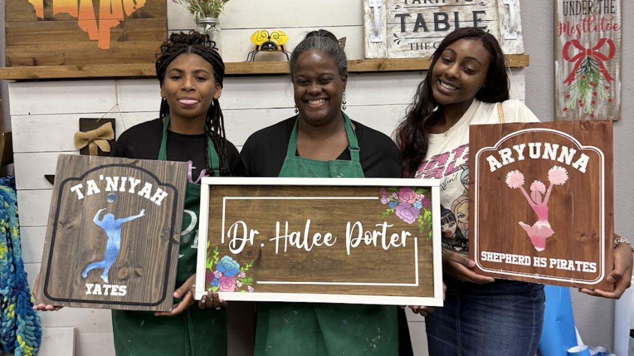 An image of three women showing their DIY wood work at The Rustic Brush