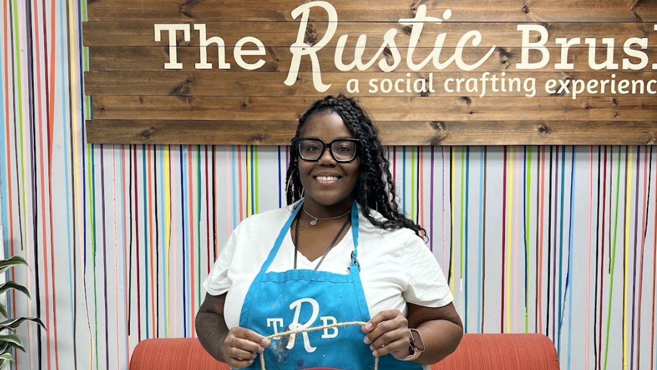 Woman wearing at The Rustic Brush holding a handmade Team Texans wooden craft sign.