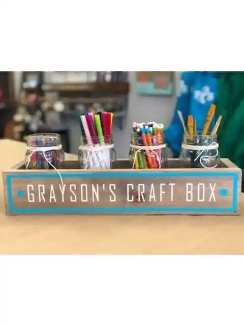Handmade wooden craft organizer with paint brushes and markers