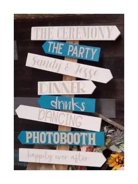 Handmade wooden directional sign featuring arrows for a ceremony, party, dinner, drinks, dancing, and photo booth.